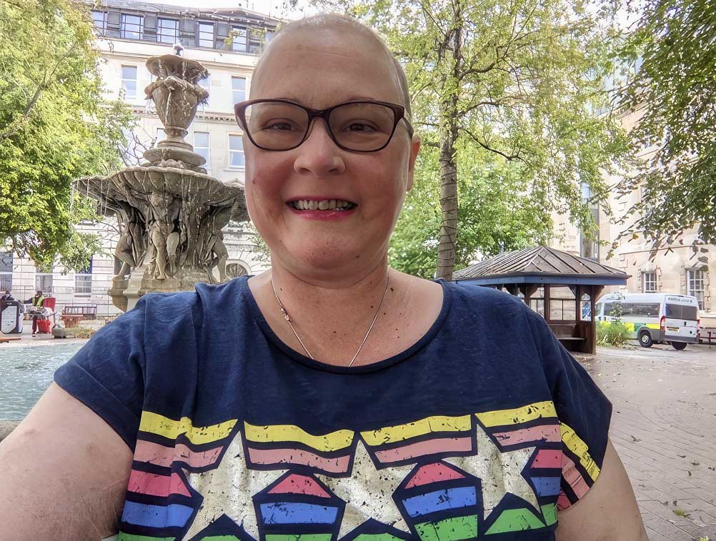 Sarah takes a photo with the fountain after her final chemo session